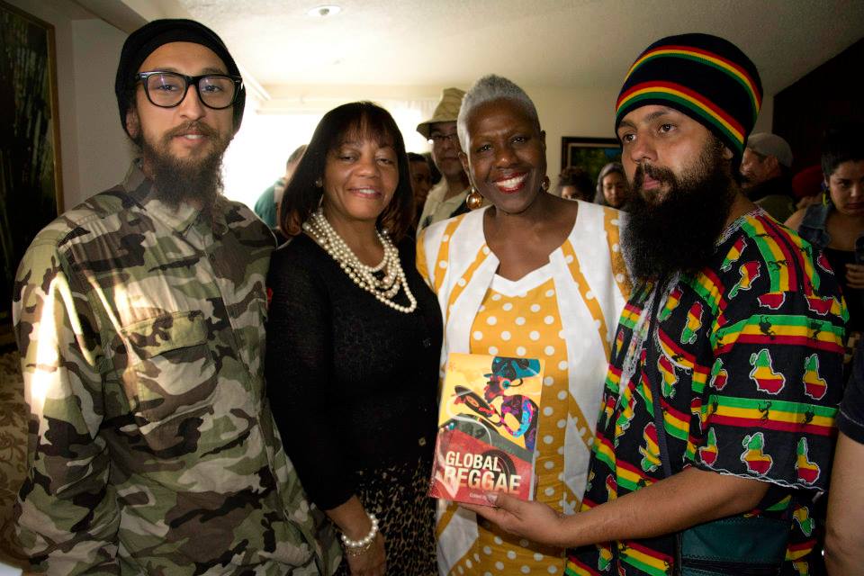 Professor Carolyn Cooper pose with her book “Global Reggae” next to Sandra Grant Griffiths, JP, Ambassador of Jamaica and Rastafarians Ras Ariel (left) and Jah Levy (right).